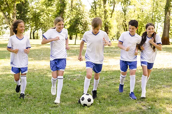 Kids playing football outdoors