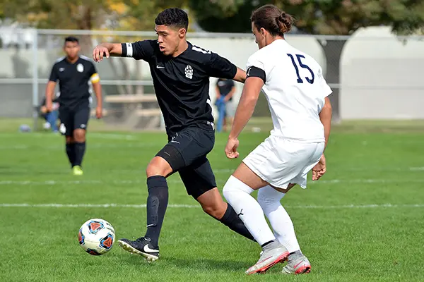 Men playing soccer field